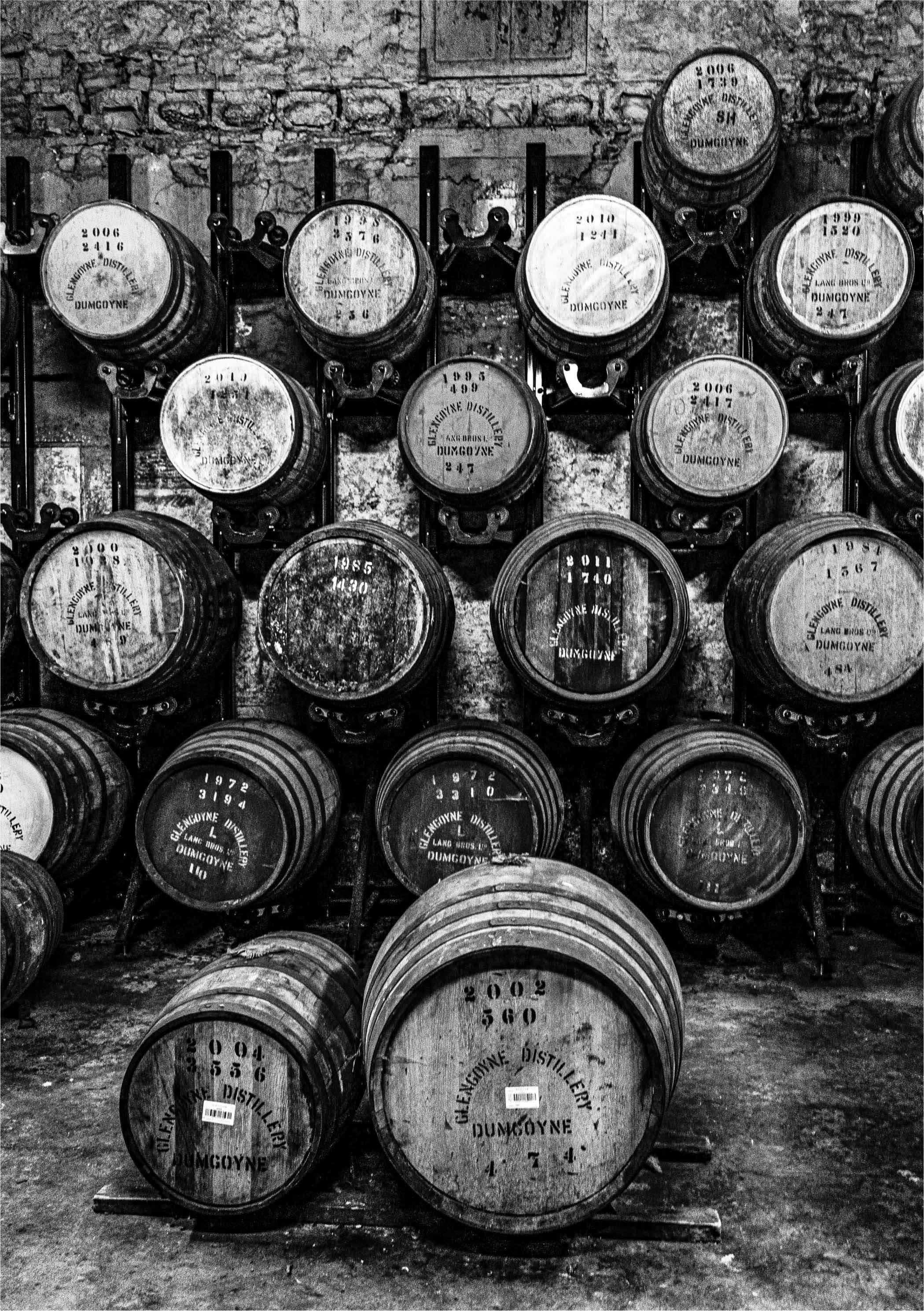 Whisky casks maturing in traditional Scottish warehouse