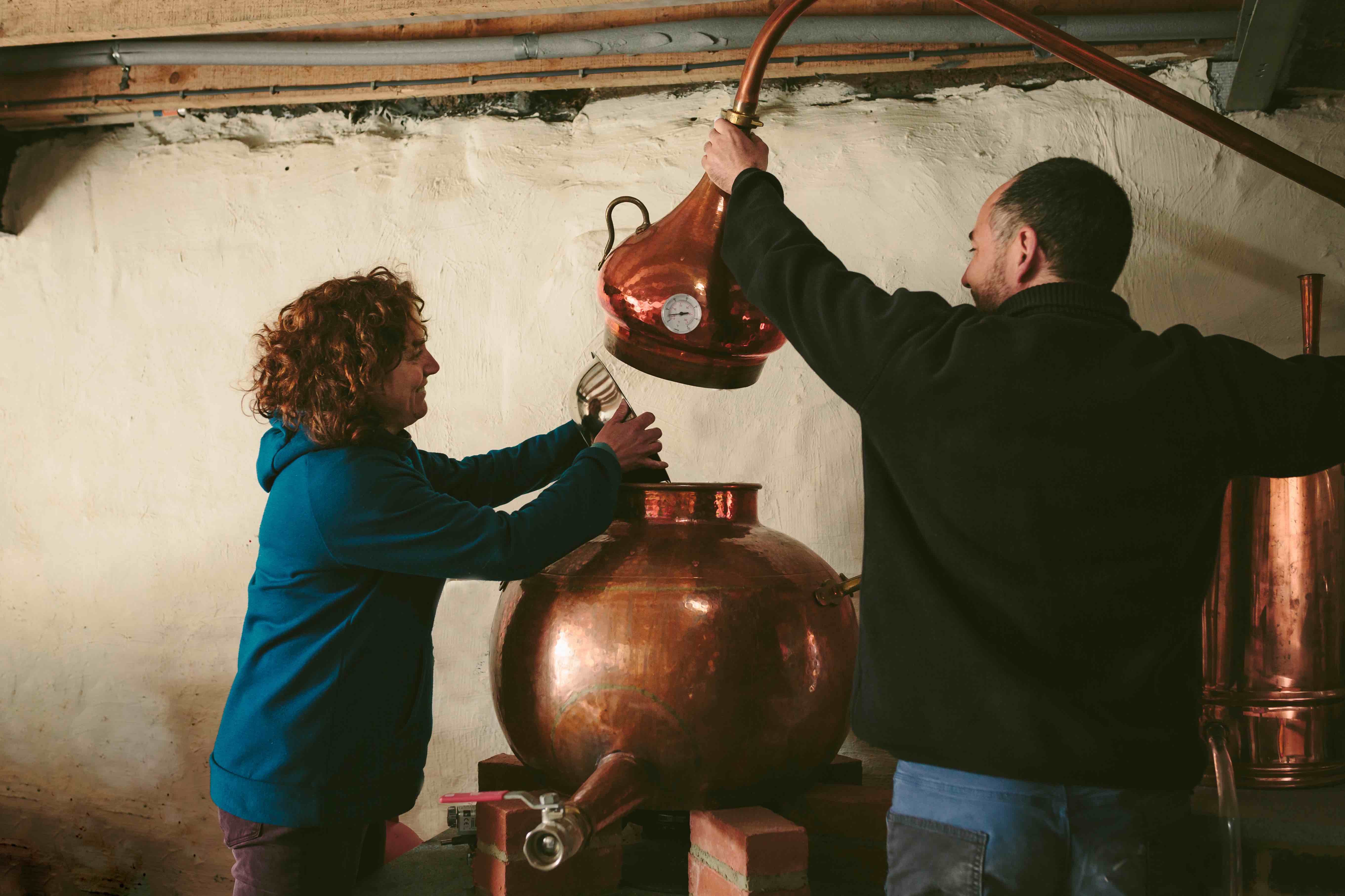 Craft distiller operating small copper pot still