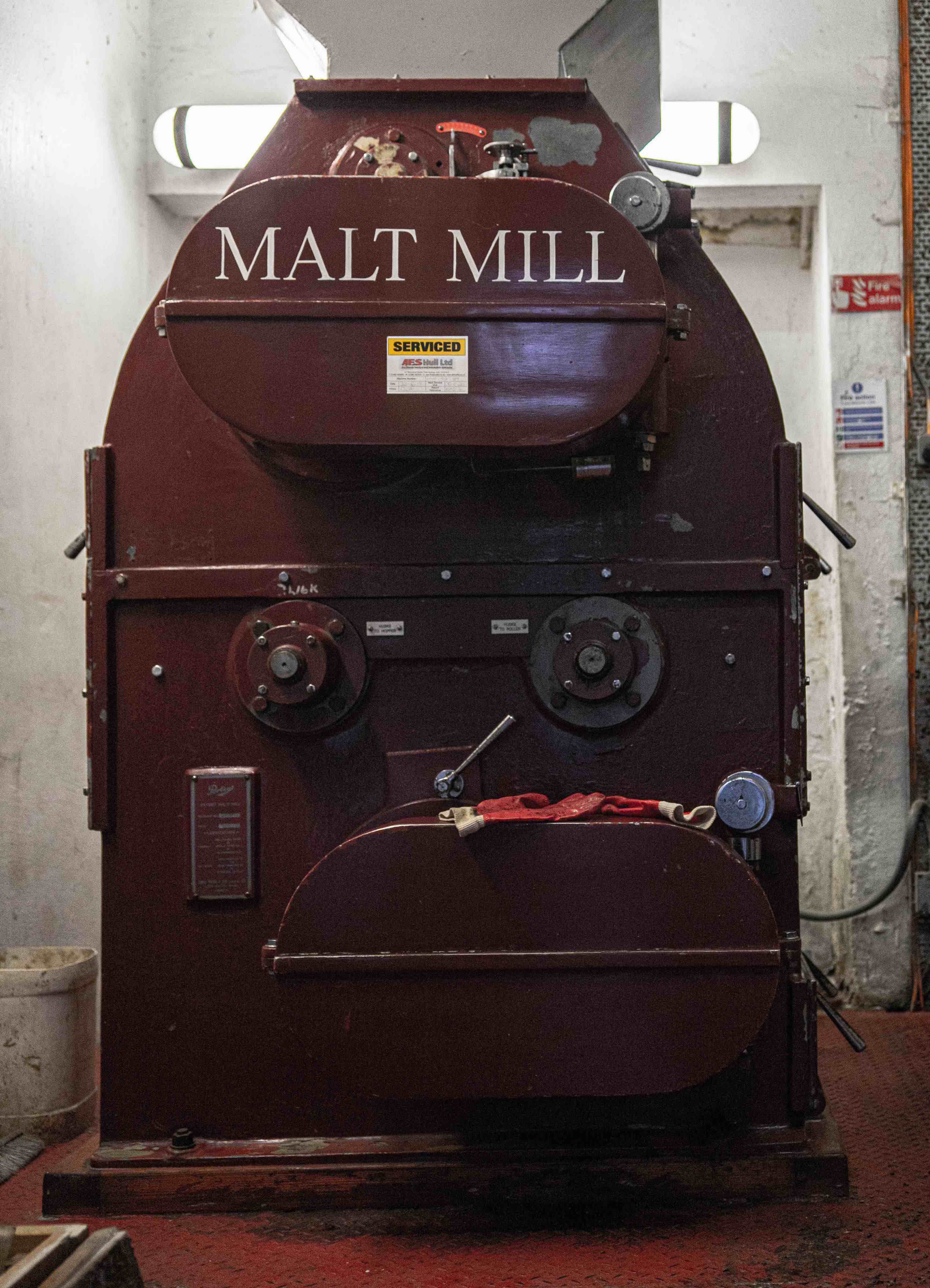 Malt mill crushing barley into grist for whisky production