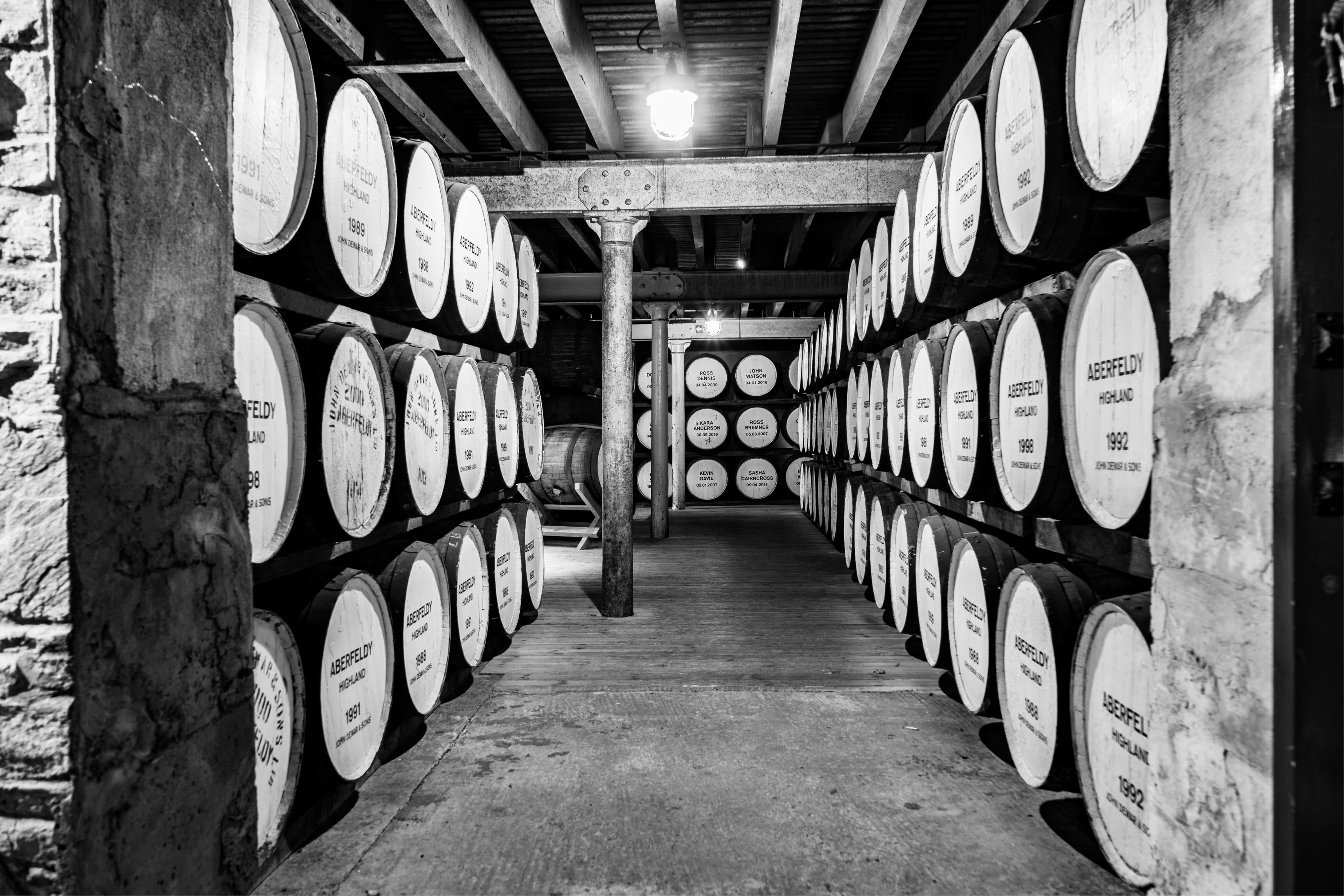 Traditional Scottish whisky warehouse with rows of oak casks