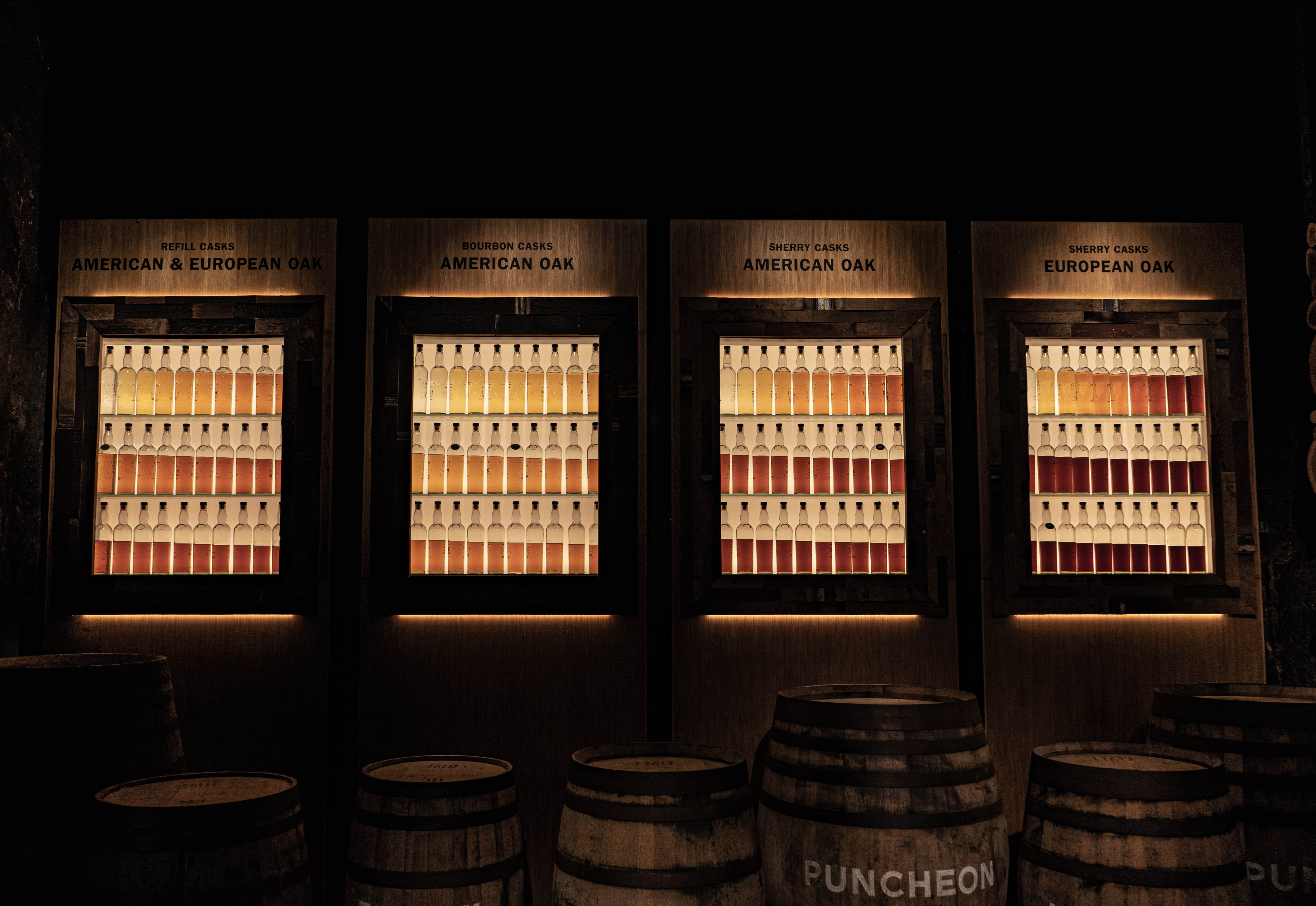 Traditional Scottish whisky warehouse with rows of oak casks